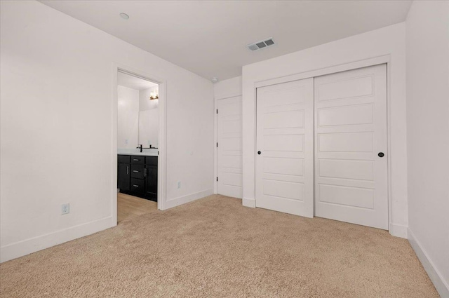 2520 S Spruce St, Visalia, CA 93292 - unfurnished bedroom with light carpet, baseboards, a closet, and connected bathroom
