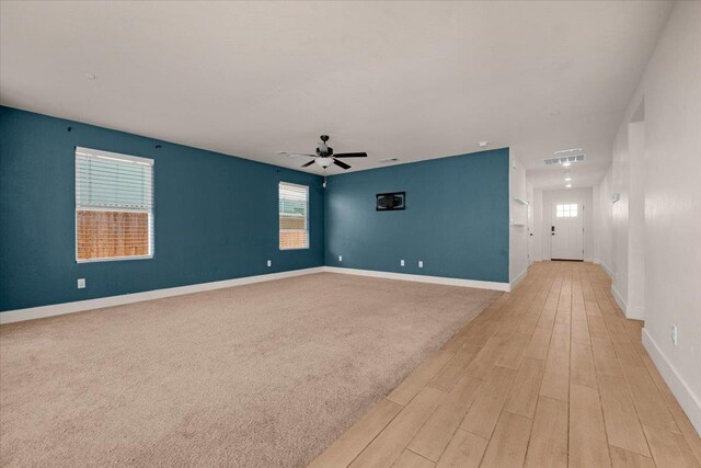 2520 S Spruce St, Visalia, CA 93292 - empty room with light wood-style flooring, a ceiling fan, and baseboards