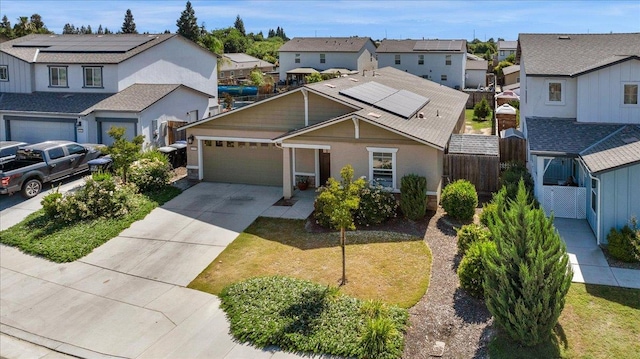 2520 S Spruce St, Visalia, CA 93292 - view of front facade with a residential view, a garage, concrete driveway, and solar panels