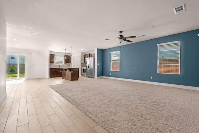 2520 S Spruce St, Visalia, CA 93292 - unfurnished living room with baseboards, a ceiling fan, light wood-style flooring, and recessed lighting