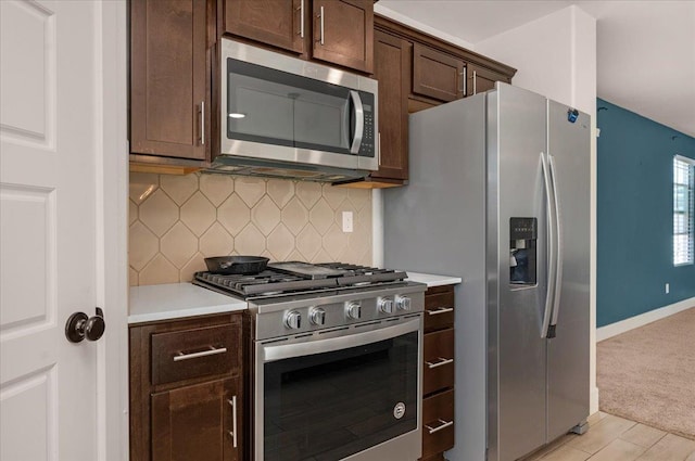 2520 S Spruce St, Visalia, CA 93292 - kitchen featuring stainless steel appliances, light countertops, dark brown cabinets, backsplash, and baseboards