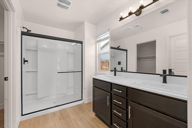 2520 S Spruce St, Visalia, CA 93292 - bathroom with a shower stall, a spacious closet, double vanity, and wood finished floors