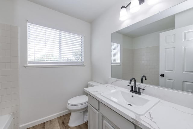 1892 E Goshen Ave, Fresno, CA 93720 - bathroom featuring wood finished floors, vanity, toilet, and baseboards