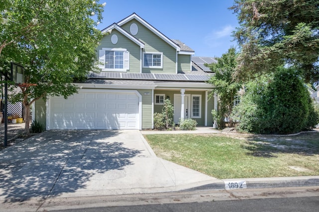 1892 E Goshen Ave, Fresno, CA 93720 - traditional-style house with concrete driveway, solar panels, an attached garage, a front yard, and a porch