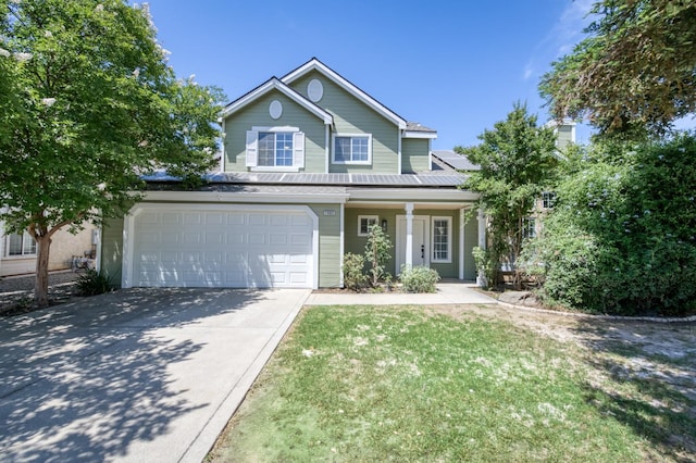 1892 E Goshen Ave, Fresno, CA 93720 - traditional home with concrete driveway, a porch, a front lawn, solar panels, and an attached garage