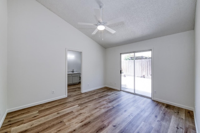 1892 E Goshen Ave, Fresno, CA 93720 - empty room with a ceiling fan, lofted ceiling, wood finished floors, a textured ceiling, and baseboards