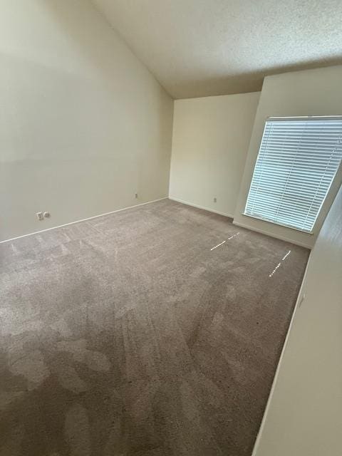 5749 N Monte Ave Unit 2, Fresno, CA 93711 - carpeted empty room with vaulted ceiling and baseboards