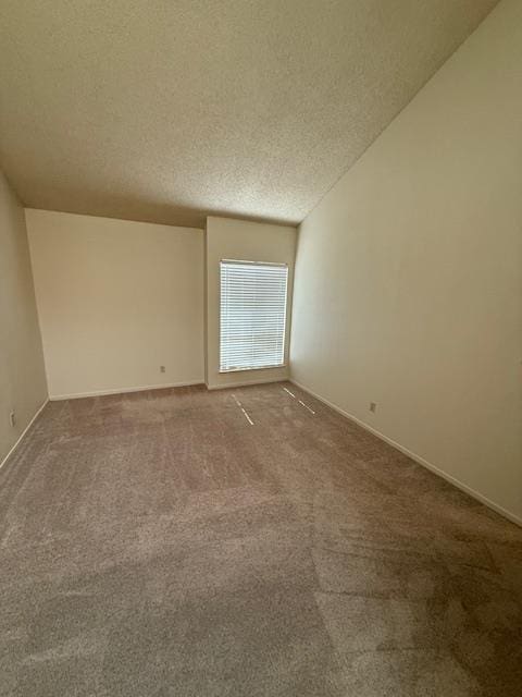 5749 N Monte Ave Unit 2, Fresno, CA 93711 - carpeted empty room featuring a textured ceiling and baseboards