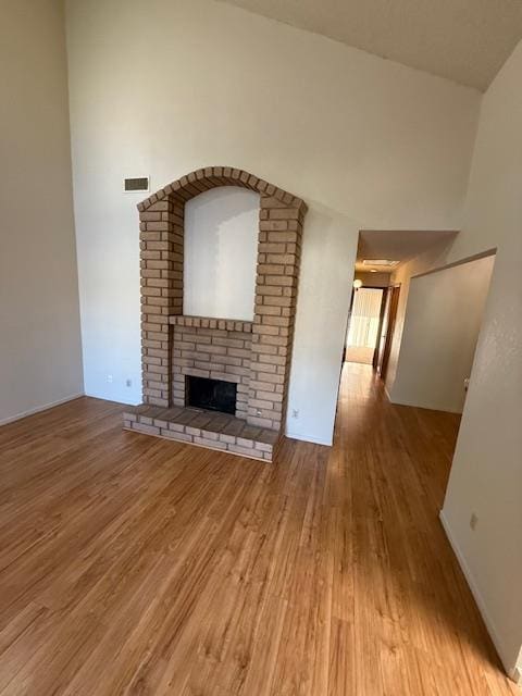5749 N Monte Ave Unit 2, Fresno, CA 93711 - unfurnished living room featuring wood finished floors, a fireplace, and baseboards
