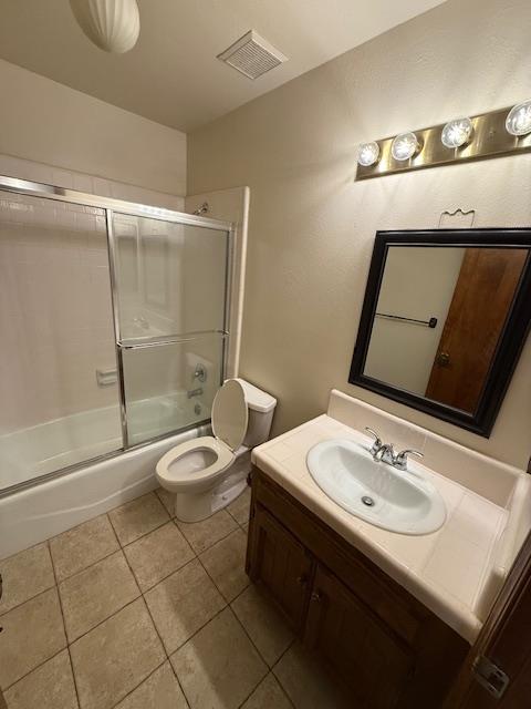 5749 N Monte Ave Unit 2, Fresno, CA 93711 - full bath with toilet, vanity, tile patterned floors, and shower / bath combination with glass door