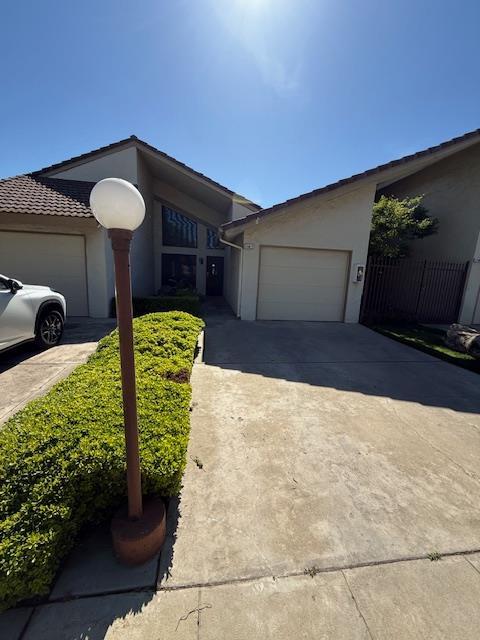 5749 N Monte Ave Unit 2, Fresno, CA 93711 - single story home featuring an attached garage, concrete driveway, and stucco siding