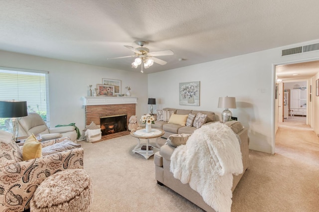 2934 N 8th St, Fresno, CA 93703 - living area featuring light colored carpet, ceiling fan, a fireplace, and a textured ceiling