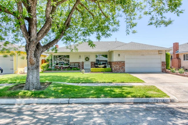 2934 N 8th St, Fresno, CA 93703 - ranch-style house featuring brick siding, a garage, concrete driveway, a front yard, and stucco siding