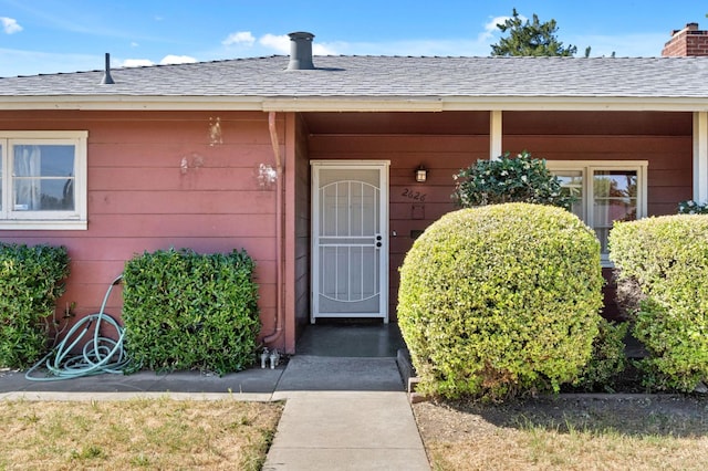 2626 E Princeton Ave, Fresno, CA 93703 - doorway to property with a shingled roof and a chimney