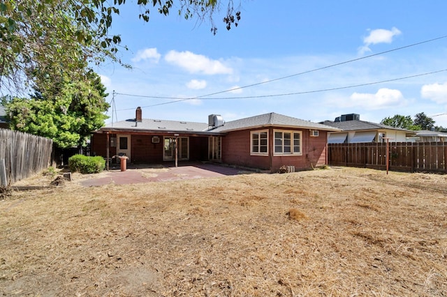 2626 E Princeton Ave, Fresno, CA 93703 - back of house with a patio, a fenced backyard, and a chimney