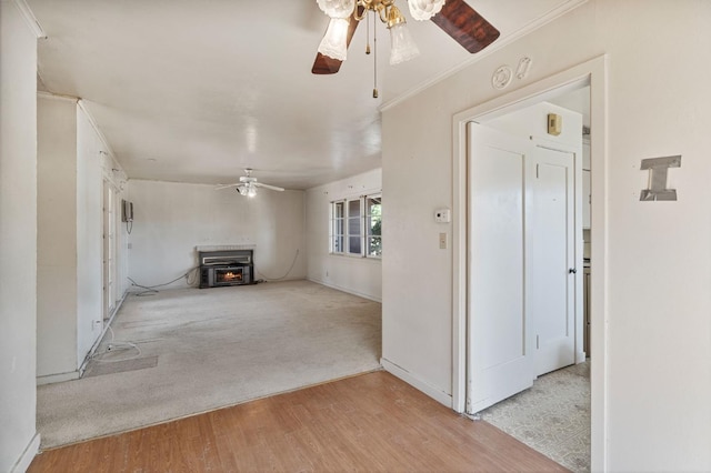 2626 E Princeton Ave, Fresno, CA 93703 - unfurnished living room with ceiling fan, light wood-type flooring, a wood stove, light colored carpet, and baseboards