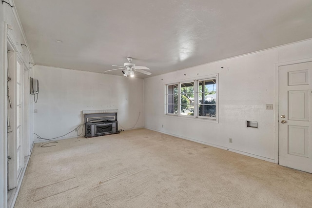2626 E Princeton Ave, Fresno, CA 93703 - unfurnished living room with a wood stove, carpet, ceiling fan, and baseboards