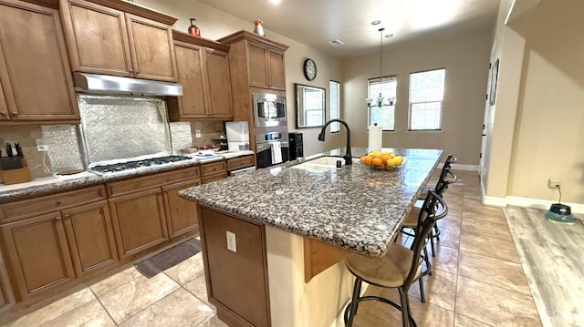 3257 Twain Ave, Clovis, CA 93619 - kitchen featuring a sink, appliances with stainless steel finishes, under cabinet range hood, and decorative backsplash