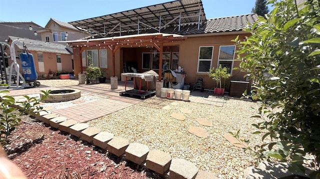 3257 Twain Ave, Clovis, CA 93619 - back of house featuring an outdoor fire pit, a pergola, a patio, a tiled roof, and stucco siding