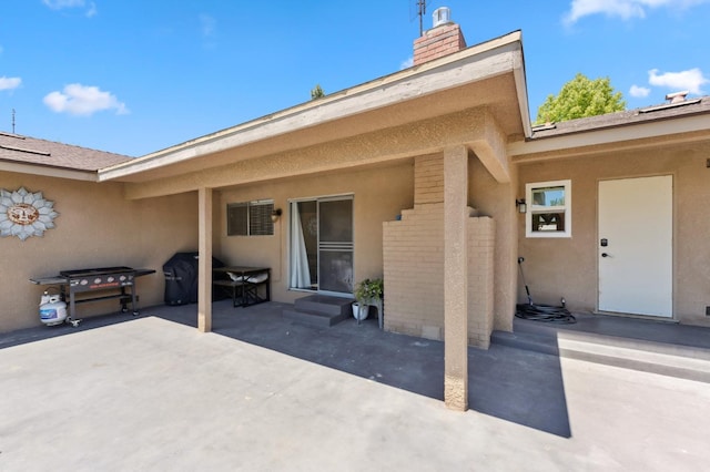 2051 E Fremont, Fresno, CA 93710 - property entrance with a patio, a chimney, and brick siding