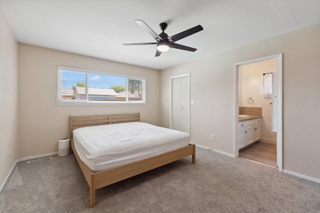 2051 E Fremont, Fresno, CA 93710 - bedroom with light colored carpet, baseboards, ensuite bath, and ceiling fan