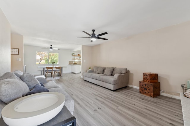 2051 E Fremont, Fresno, CA 93710 - living area featuring light wood finished floors, ceiling fan, and baseboards