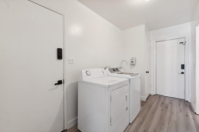 2051 E Fremont, Fresno, CA 93710 - laundry area with washing machine and dryer, light wood-style flooring, and baseboards