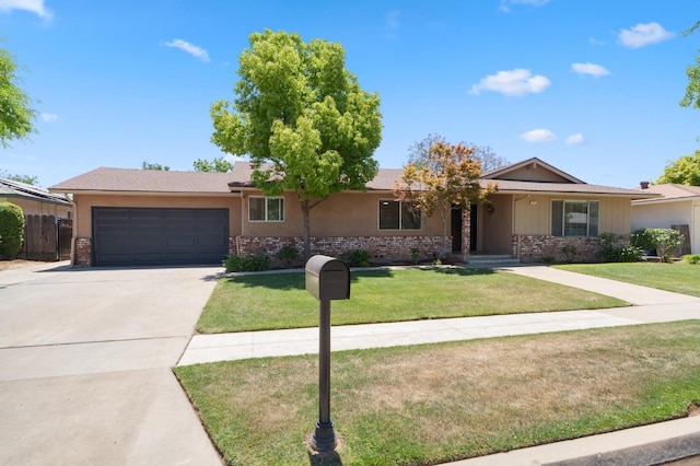 2051 E Fremont, Fresno, CA 93710 - ranch-style home featuring brick siding, an attached garage, concrete driveway, and a front yard