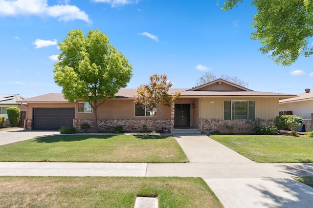 2051 E Fremont, Fresno, CA 93710 - ranch-style home featuring brick siding, a front yard, a garage, and concrete driveway
