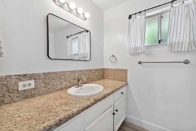 2051 E Fremont, Fresno, CA 93710 - bathroom featuring vanity, baseboards, and wood finished floors