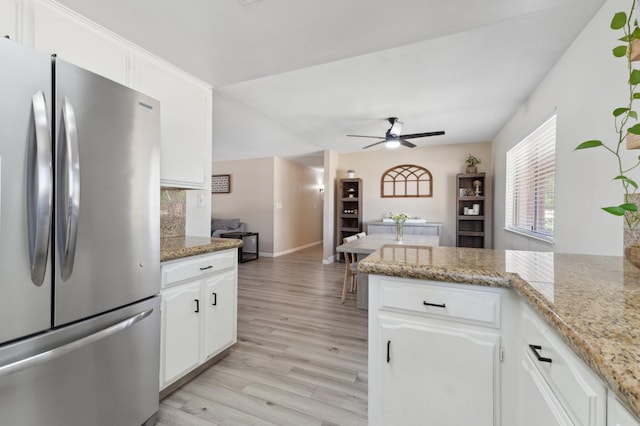 2051 E Fremont, Fresno, CA 93710 - kitchen featuring freestanding refrigerator, light wood finished floors, ceiling fan, white cabinetry, and baseboards