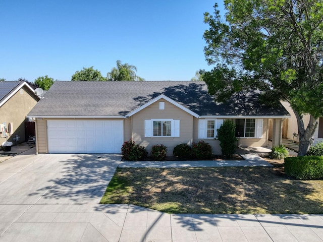 5164 W Michigan Ave, Fresno, CA 93722 - ranch-style house featuring an attached garage, driveway, and roof with shingles