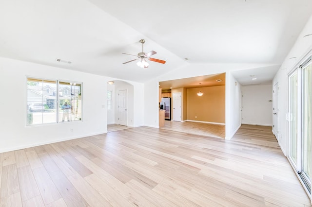 5164 W Michigan Ave, Fresno, CA 93722 - unfurnished living room with light wood-style floors, lofted ceiling, ceiling fan, arched walkways, and baseboards