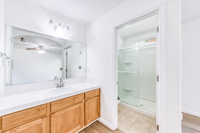 5164 W Michigan Ave, Fresno, CA 93722 - bathroom featuring ceiling fan, a shower stall, vanity, toilet, and tile patterned flooring