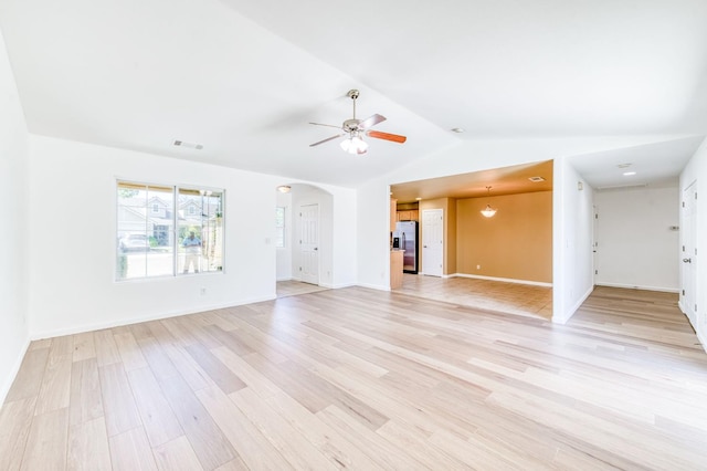 5164 W Michigan Ave, Fresno, CA 93722 - unfurnished living room with light wood-style flooring, arched walkways, a ceiling fan, lofted ceiling, and baseboards