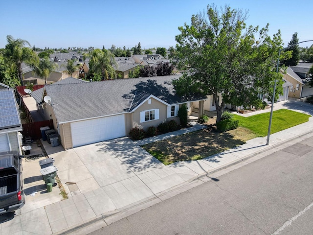 5164 W Michigan Ave, Fresno, CA 93722 - view of front of property featuring an attached garage, concrete driveway, a residential view, and stucco siding