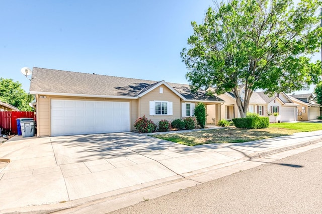 5164 W Michigan Ave, Fresno, CA 93722 - view of front facade featuring driveway and a garage