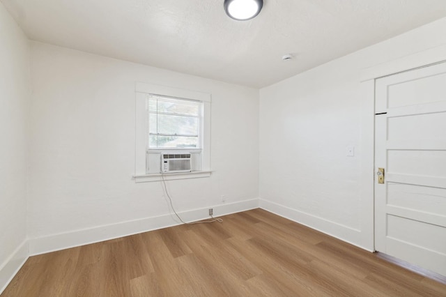 1593 N Glenn Ave, Fresno, CA 93728 - empty room with light wood-type flooring, cooling unit, and a smoke detector