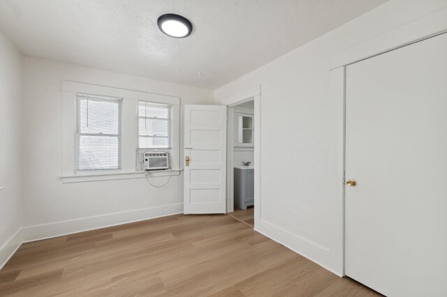 1593 N Glenn Ave, Fresno, CA 93728 - unfurnished bedroom with light wood-style flooring, cooling unit, and a closet