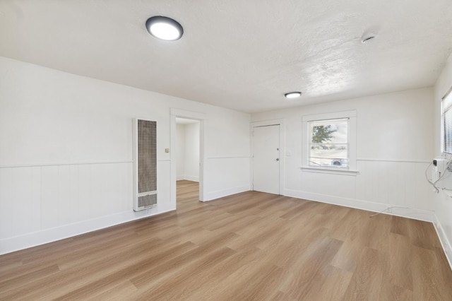 1593 N Glenn Ave, Fresno, CA 93728 - spare room featuring a heating unit, light wood-type flooring, a wainscoted wall, and a smoke detector