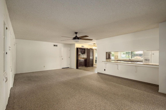 2081 Santa Ana Ave, Clovis, CA 93611 - unfurnished living room with ceiling fan, carpet, and a textured ceiling