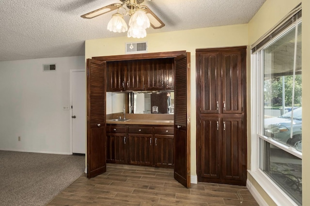 2081 Santa Ana Ave, Clovis, CA 93611 - kitchen featuring a textured ceiling, ceiling fan, a sink, baseboards, and dark wood-style floors