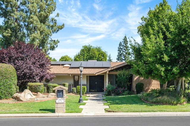 2081 Santa Ana Ave, Clovis, CA 93611 - view of front of home with a front lawn and roof mounted solar panels