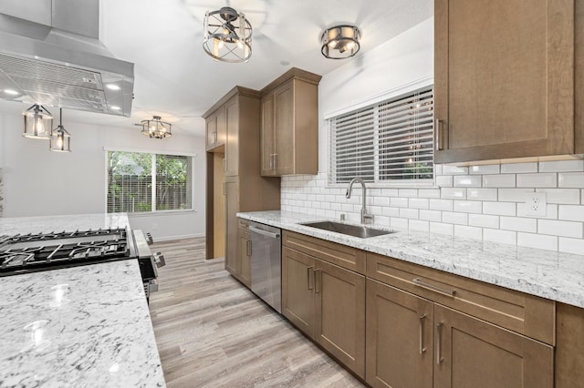 3752 N Augusta St, Fresno, CA 93726 - kitchen with a sink, island range hood, stainless steel appliances, light wood-style floors, and tasteful backsplash