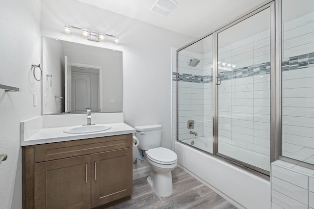3752 N Augusta St, Fresno, CA 93726 - full bath featuring vanity, toilet, wood finished floors, and combined bath / shower with glass door