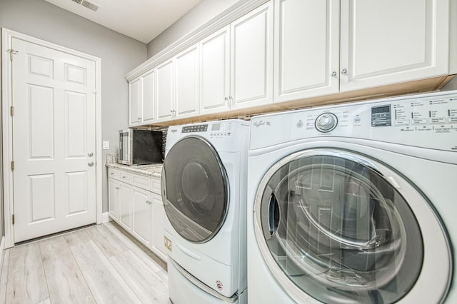 3081 Serena Ave, Clovis, CA 93619 - laundry area with washer and dryer, cabinet space, and light wood-style floors