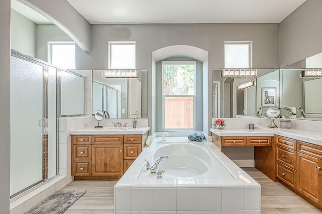 3081 Serena Ave, Clovis, CA 93619 - full bath with a stall shower, a bath, two vanities, and wood finished floors