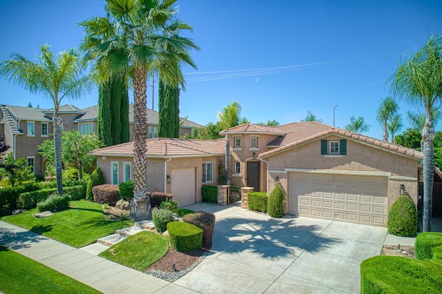 3081 Serena Ave, Clovis, CA 93619 - mediterranean / spanish-style house with stucco siding, driveway, an attached garage, a tiled roof, and a front yard