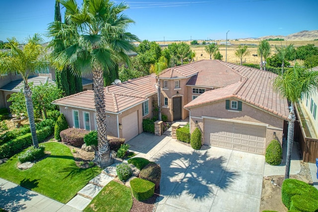 3081 Serena Ave, Clovis, CA 93619 - mediterranean / spanish house with concrete driveway, stucco siding, a tiled roof, and an attached garage