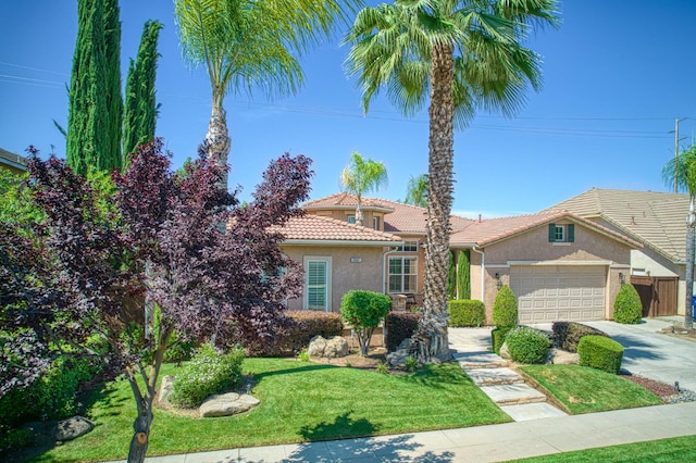3081 Serena Ave, Clovis, CA 93619 - view of front of home featuring stucco siding, an attached garage, driveway, a tile roof, and a front lawn